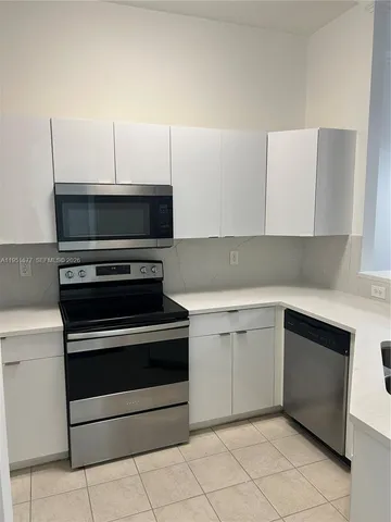 a kitchen with cabinets and appliances