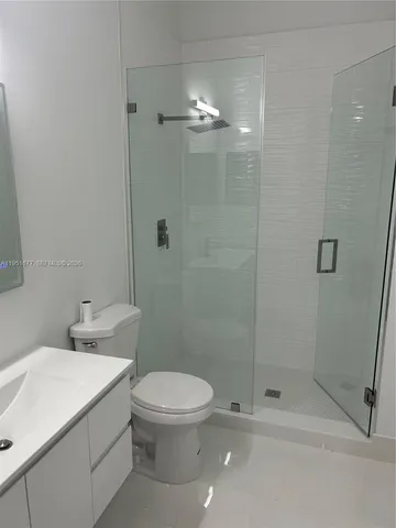 a bathroom with a toilet a sink and shower
