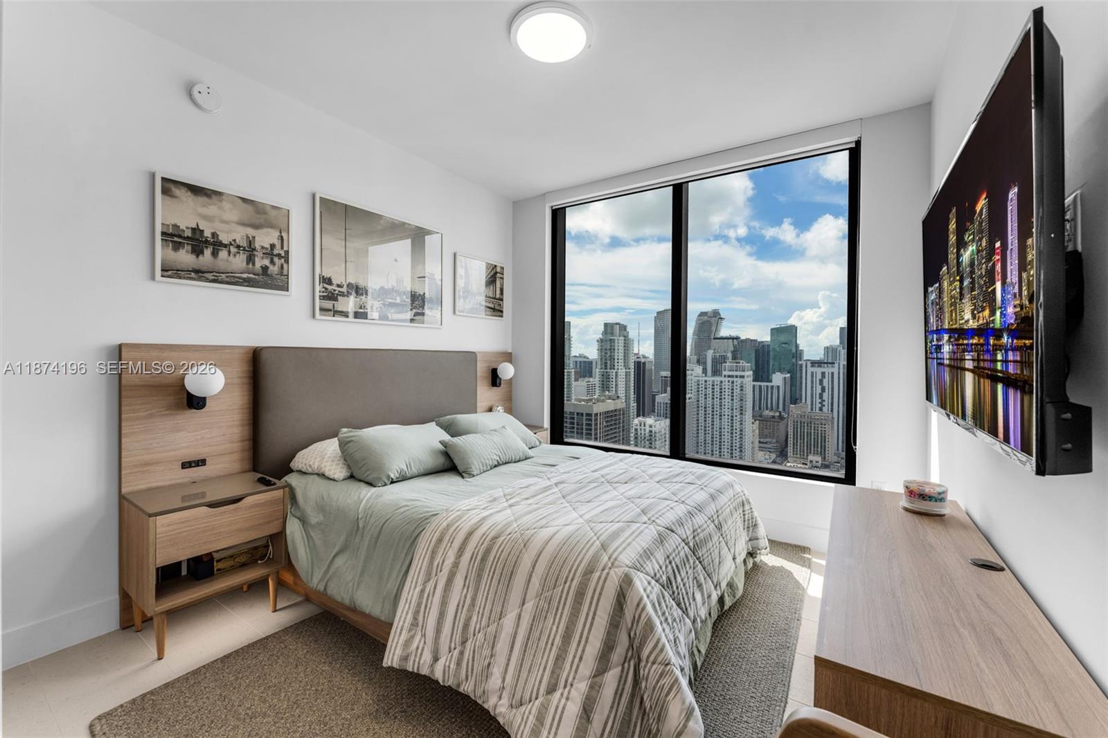 159 Northeast 6th Street, Unit 4016 Miami, FL 33132 - Photo 12 of 50 a bedroom with a bed and a large window