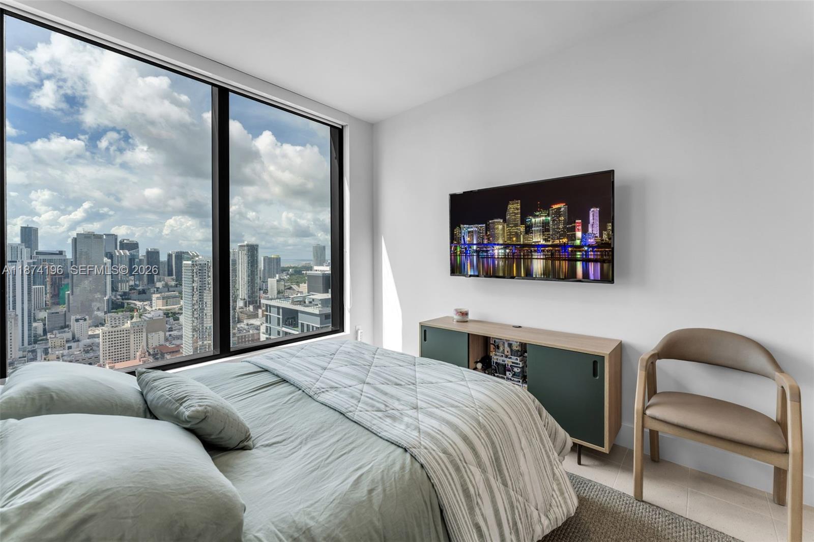 159 Northeast 6th Street, Unit 4016 Miami, FL 33132 - Photo 13 of 50 a bedroom with a bed and a flat screen tv