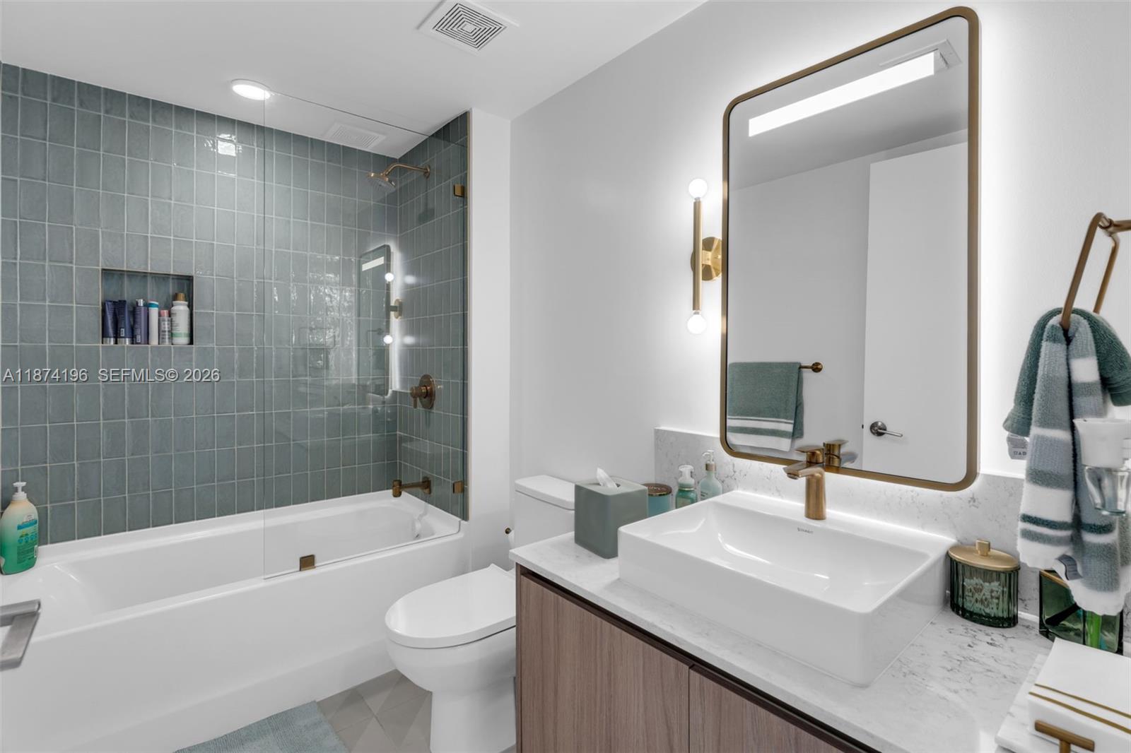 159 Northeast 6th Street, Unit 4016 Miami, FL 33132 - Photo 20 of 50 a bathroom with a sink a toilet and a large mirror