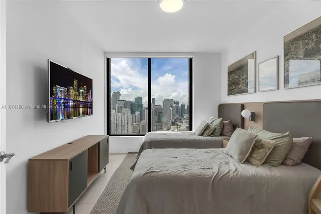 a living room with furniture and a floor to ceiling window