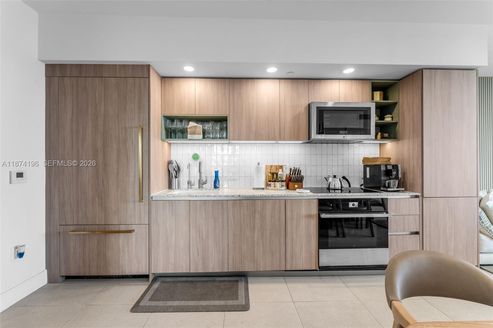 159 Northeast 6th Street, Unit 4016 Miami, FL 33132 - Photo 7 of 50 a kitchen with stainless steel appliances a refrigerator a stove a microwave and cabinets