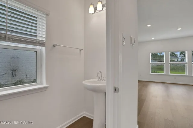 a bathroom with double vanity sink and a mirror