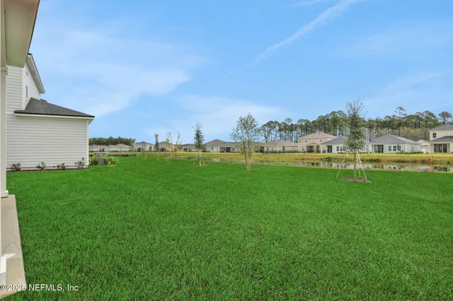a view of a garden with flowers and trees