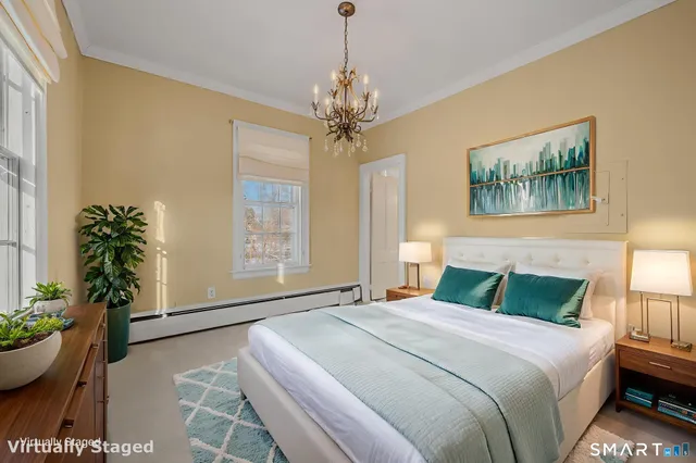 a bedroom with furniture and a chandelier
