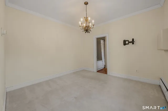 a view of a chandelier in big room and chandelier