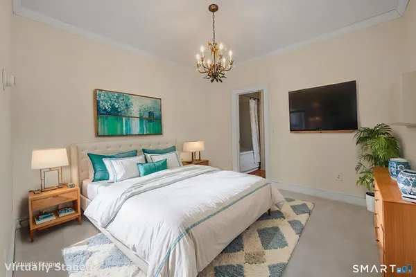 a bedroom with a bed and a flat screen tv