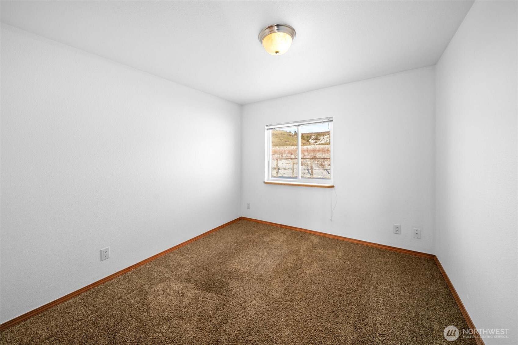 565 Boyd Loop Road Manson, WA 98831 - Photo 12 of 27 an empty room with a window