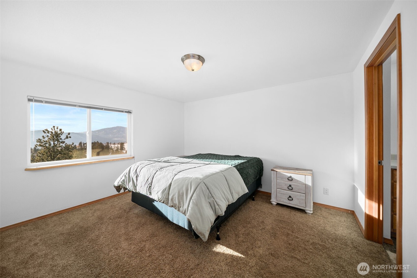 565 Boyd Loop Road Manson, WA 98831 - Photo 14 of 27 a bedroom with a bed and a window
