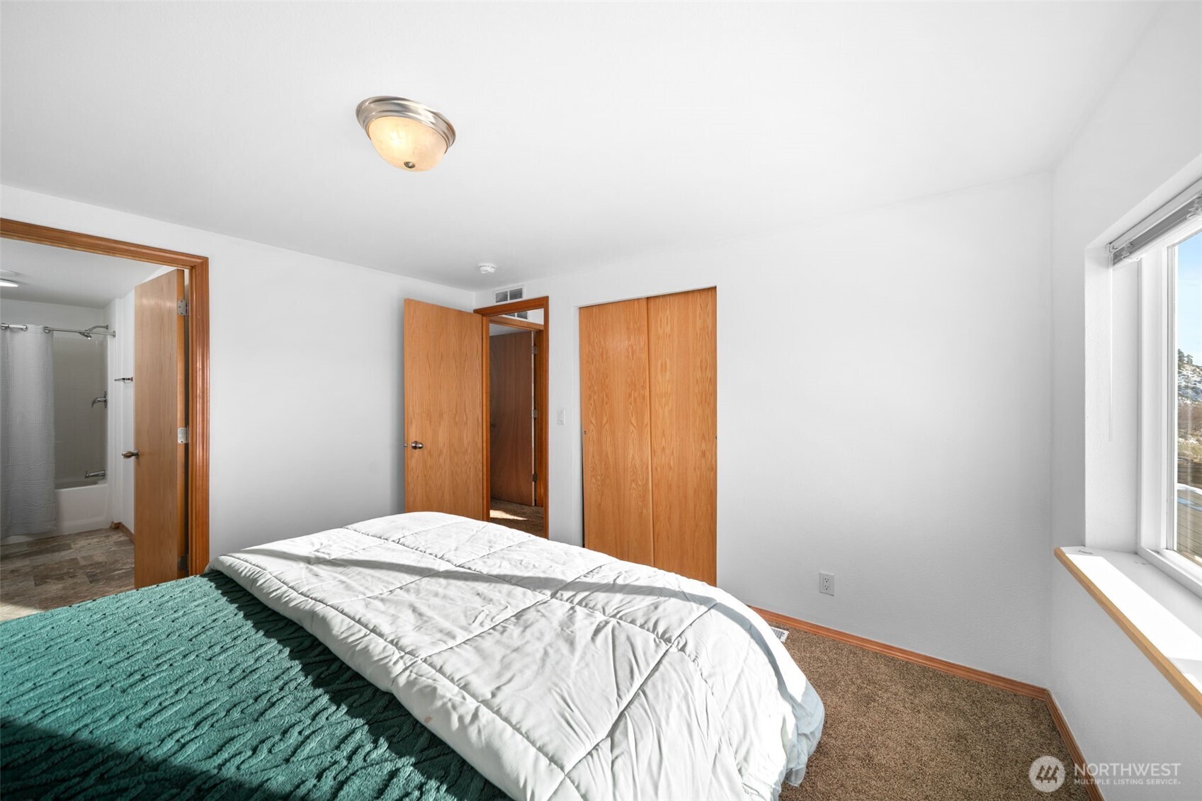 565 Boyd Loop Road Manson, WA 98831 - Photo 17 of 39 a bedroom with a bed and a window