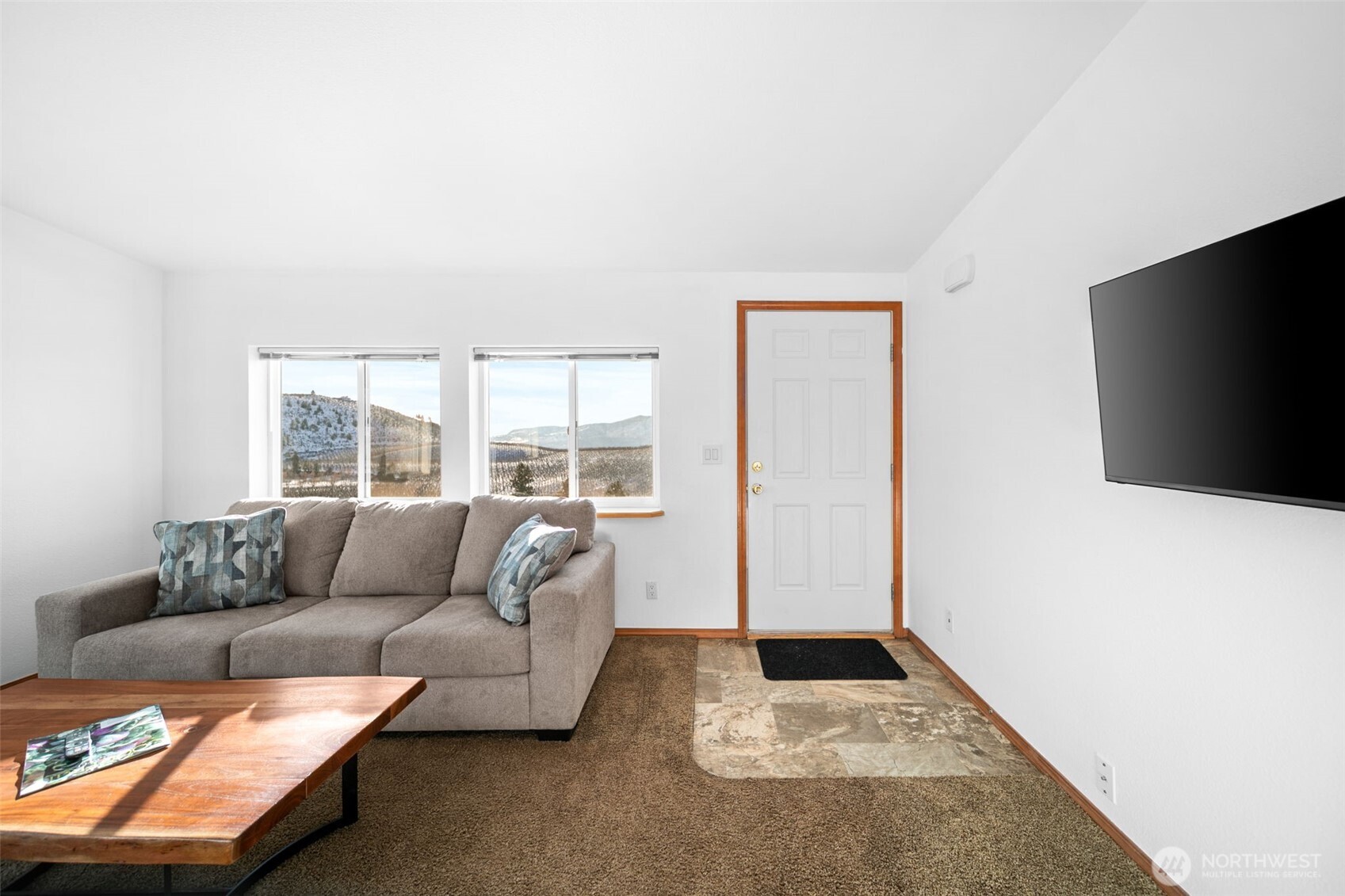 565 Boyd Loop Road Manson, WA 98831 - Photo 2 of 27 a living room with furniture and a flat screen tv