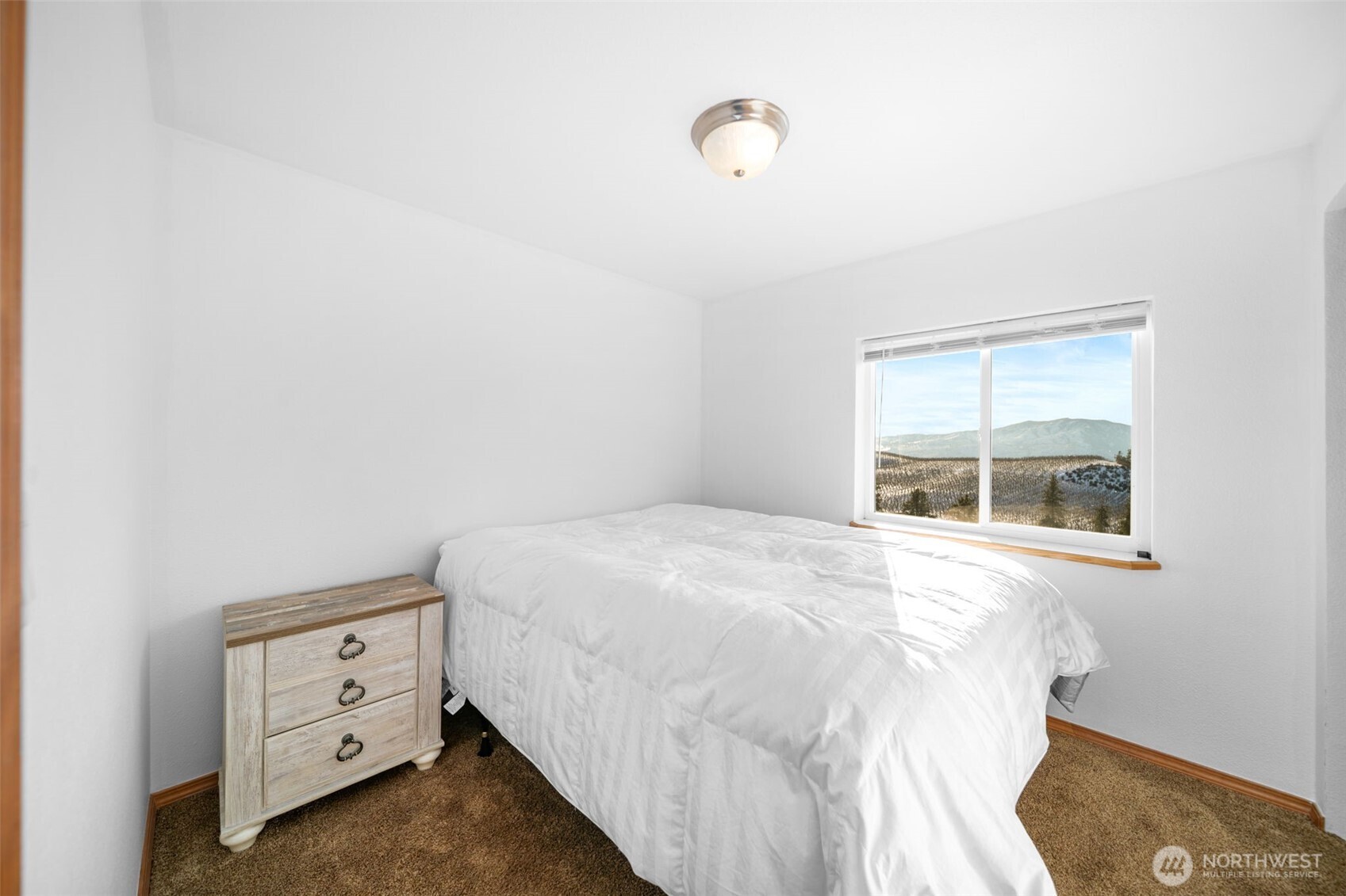 565 Boyd Loop Road Manson, WA 98831 - Photo 6 of 27 a bedroom with a bed and a window