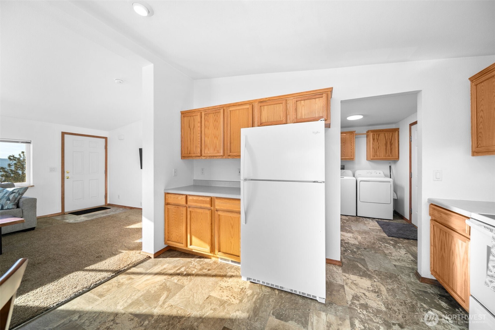 565 Boyd Loop Road Manson, WA 98831 - Photo 8 of 27 a view of a kitchen with a refrigerator a sink oven and a window