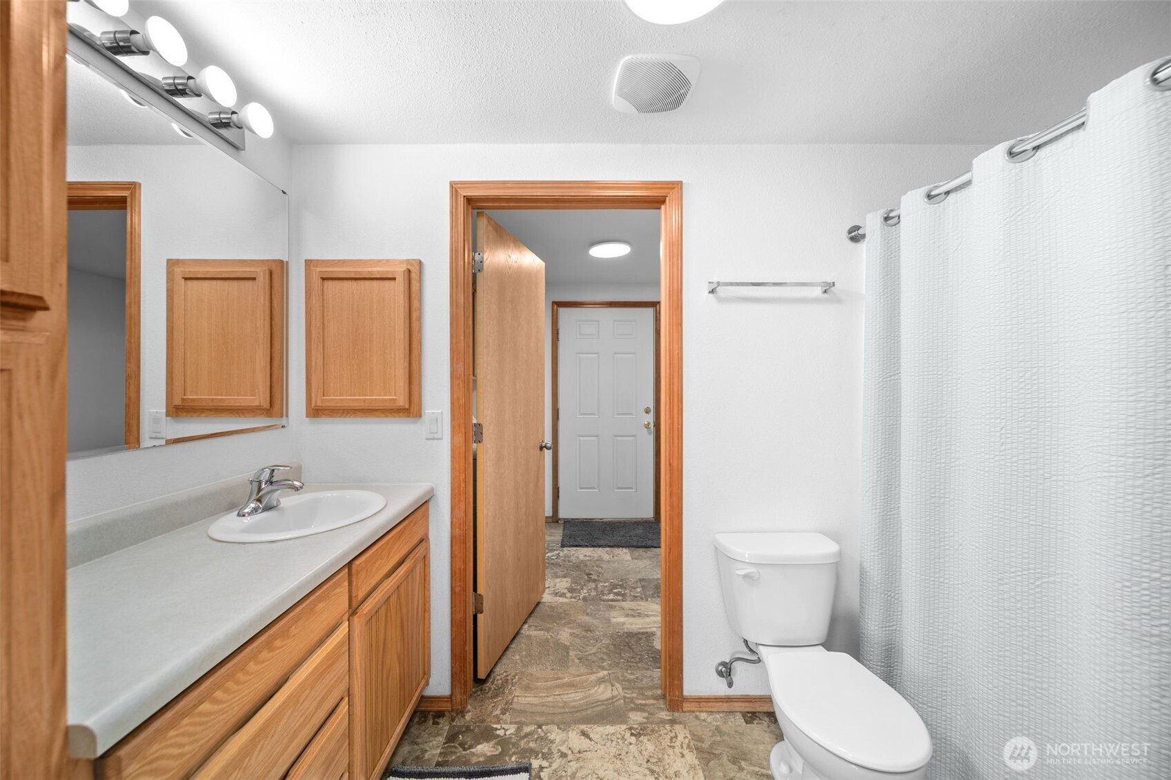 565 Boyd Loop Road Manson, WA 98831 - Photo 10 of 27 a bathroom with a granite countertop sink toilet and shower