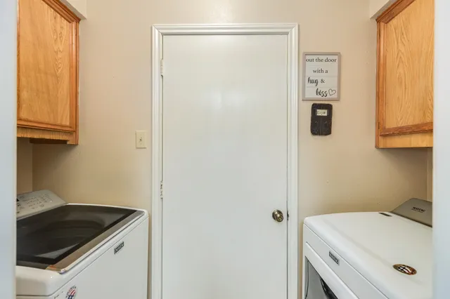 a utility room with a sink dryer and washer
