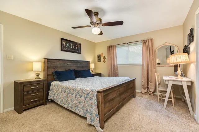 a bedroom with a bed and a table in it