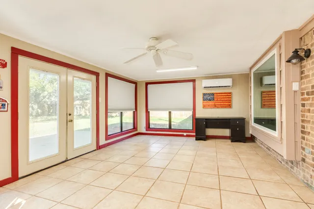 a view of an empty room with window a livingroom and furniture