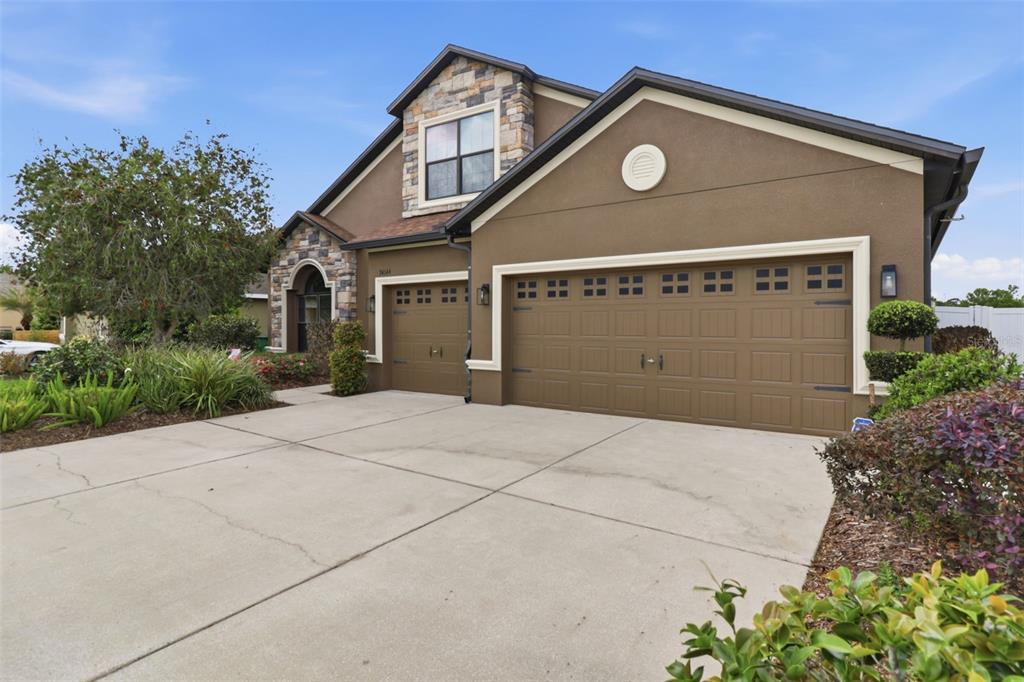 34144 Spring Oak Trail Wesley Chapel, FL 33545 - Photo 24 of 37 a front view of a house with a yard and garage