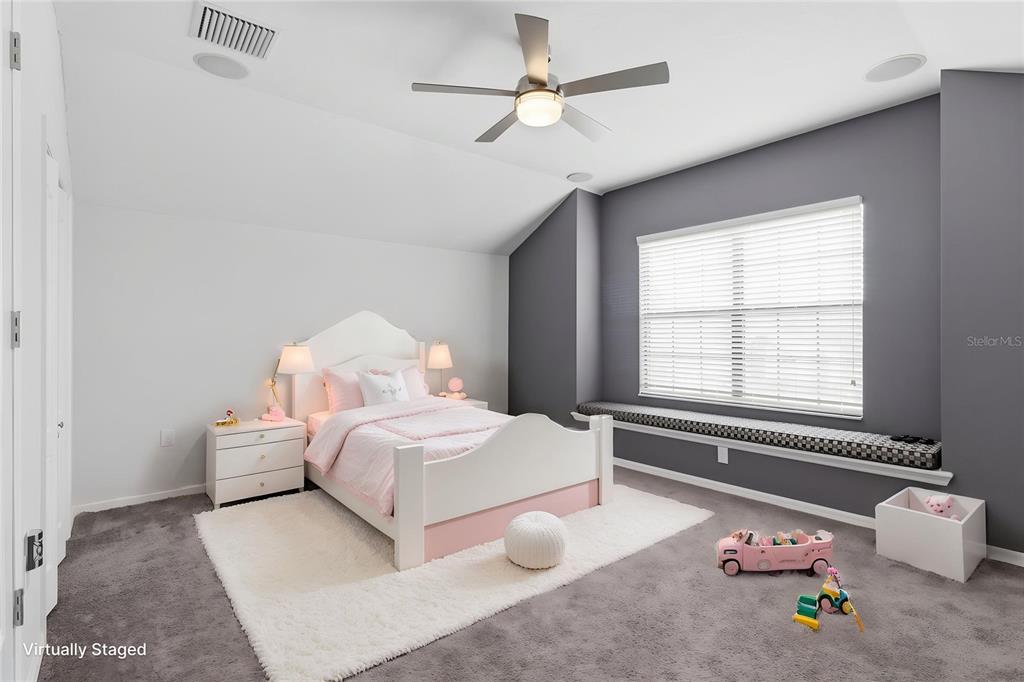 34144 Spring Oak Trail Wesley Chapel, FL 33545 - Photo 7 of 37 a bedroom with a bed and a chandelier