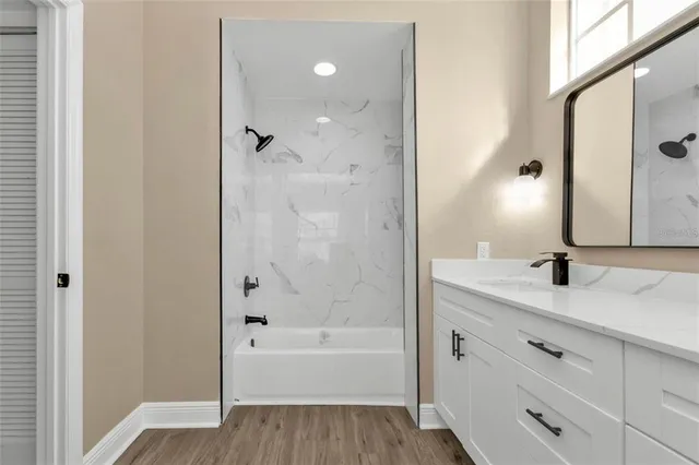 a bathroom with a shower and a window