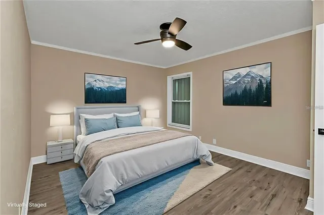 a bedroom with a bed and a painting on the wall