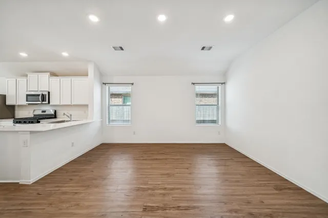 a view of kitchen with granite countertop cabinets and wooden floor