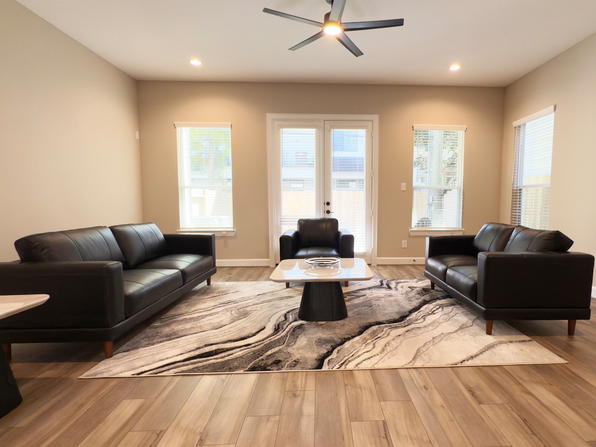 4309 B Dickson Street Houston, TX 77007 - Photo 2 of 12 The ROCburne’s living room is designed for both comfort and style, featuring soaring ceilings, abundant natural light, and an open flow that seamlessly connects to the kitchen and dining areas—perfect for both everyday living and entertaining. Image depicts home as-is.