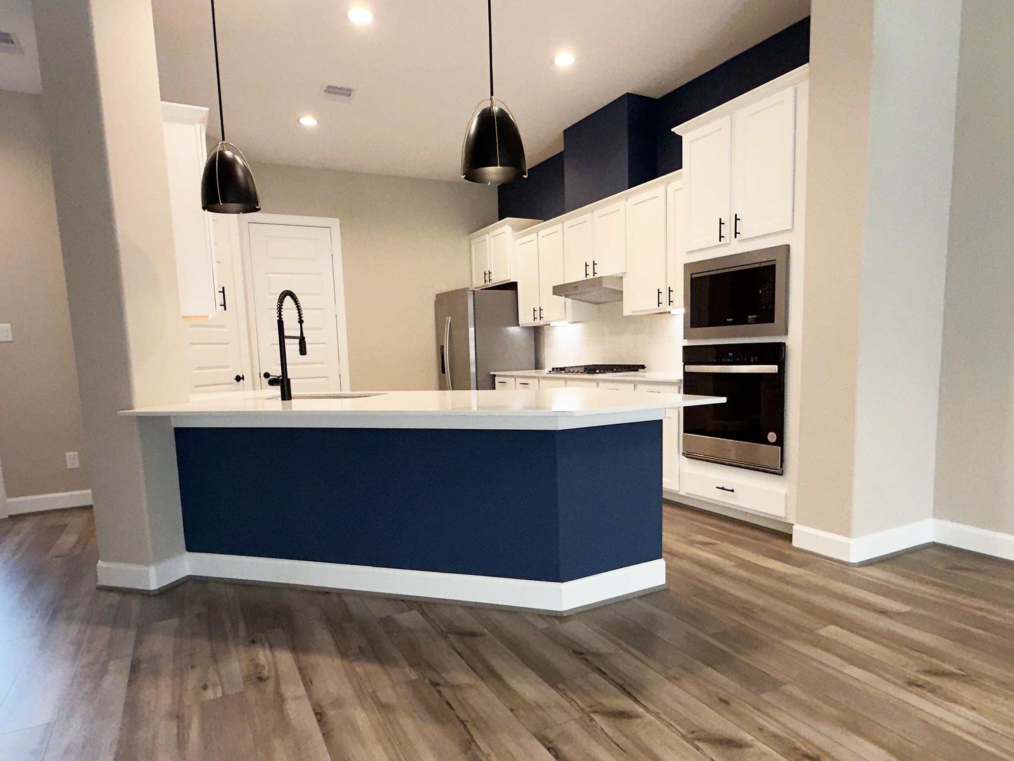 4309 B Dickson Street Houston, TX 77007 - Photo 3 of 11 Experience gourmet living in the ROCburne’s kitchen, where high-end finishes, a statement island, and premium appliances set the stage for effortless entertaining. Image depicts home as-is.