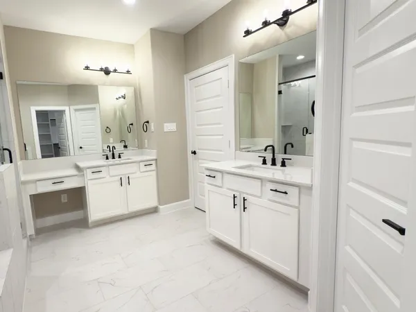 a kitchen with stainless steel appliances kitchen island granite countertop a large counter top a sink a stove and a wooden floors