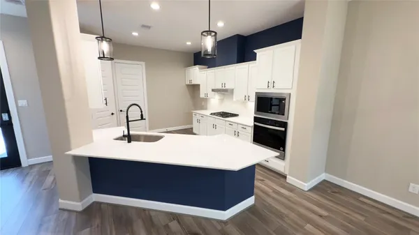 a spacious bathroom with a double vanity sink mirror and bathtub
