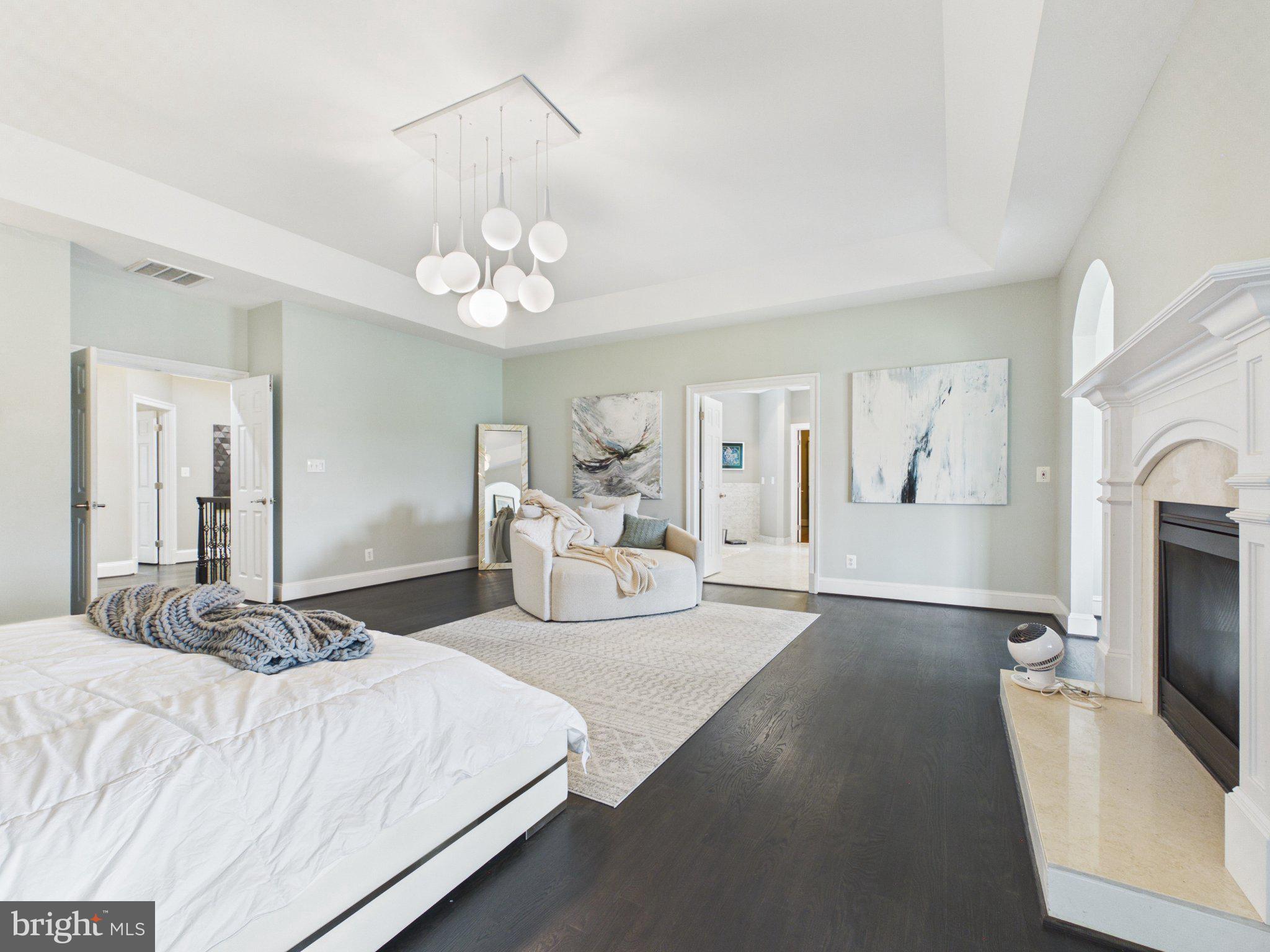 38565 Piggott Bottom Road Hamilton, VA 20158 - Photo 40 of 85 a bedroom with a bed a chandelier and flat screen tv