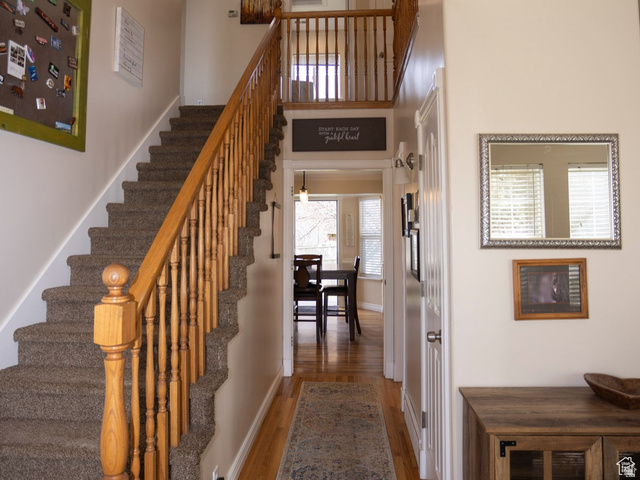 7532 North Castle Rock Road Eagle Mountain, UT 84005 - Photo 3 of 40 Stairway featuring wood finished floors and a high ceiling