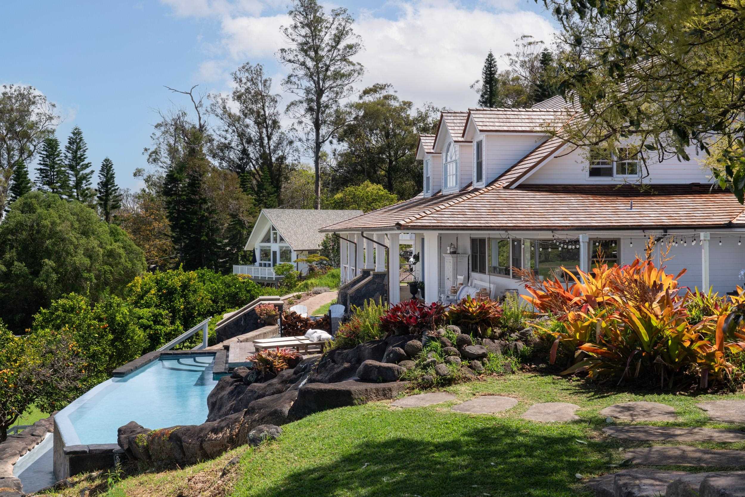 1630 Olinda Road Makawao, HI 96768 - Photo 20 of 50 a view of a house with garden and lawn chairs