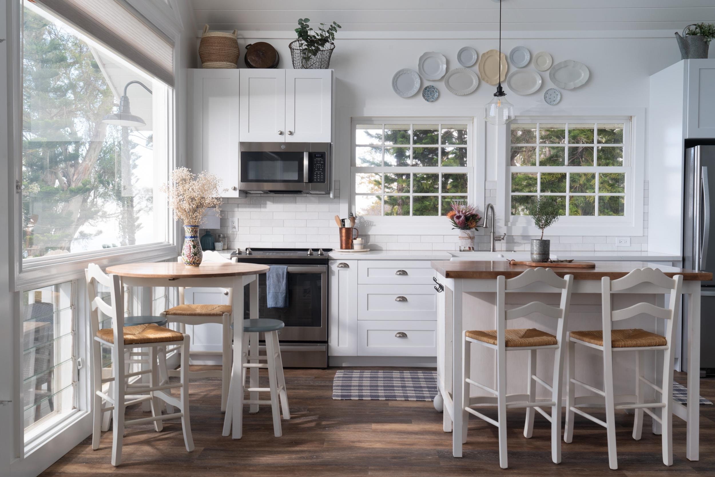 1630 Olinda Road Makawao, HI 96768 - Photo 42 of 50 a kitchen with a table chairs microwave and cabinets