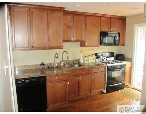 60 Glenville Road Edison, NJ 08817 - Photo 2 of 8 a kitchen with stainless steel appliances granite countertop a sink stove and refrigerator