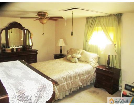 60 Glenville Road Edison, NJ 08817 - Photo 6 of 8 a bedroom with a bed and a dresser