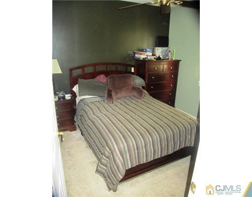 60 Glenville Road Edison, NJ 08817 - Photo 7 of 8 a bedroom with a bed and a table