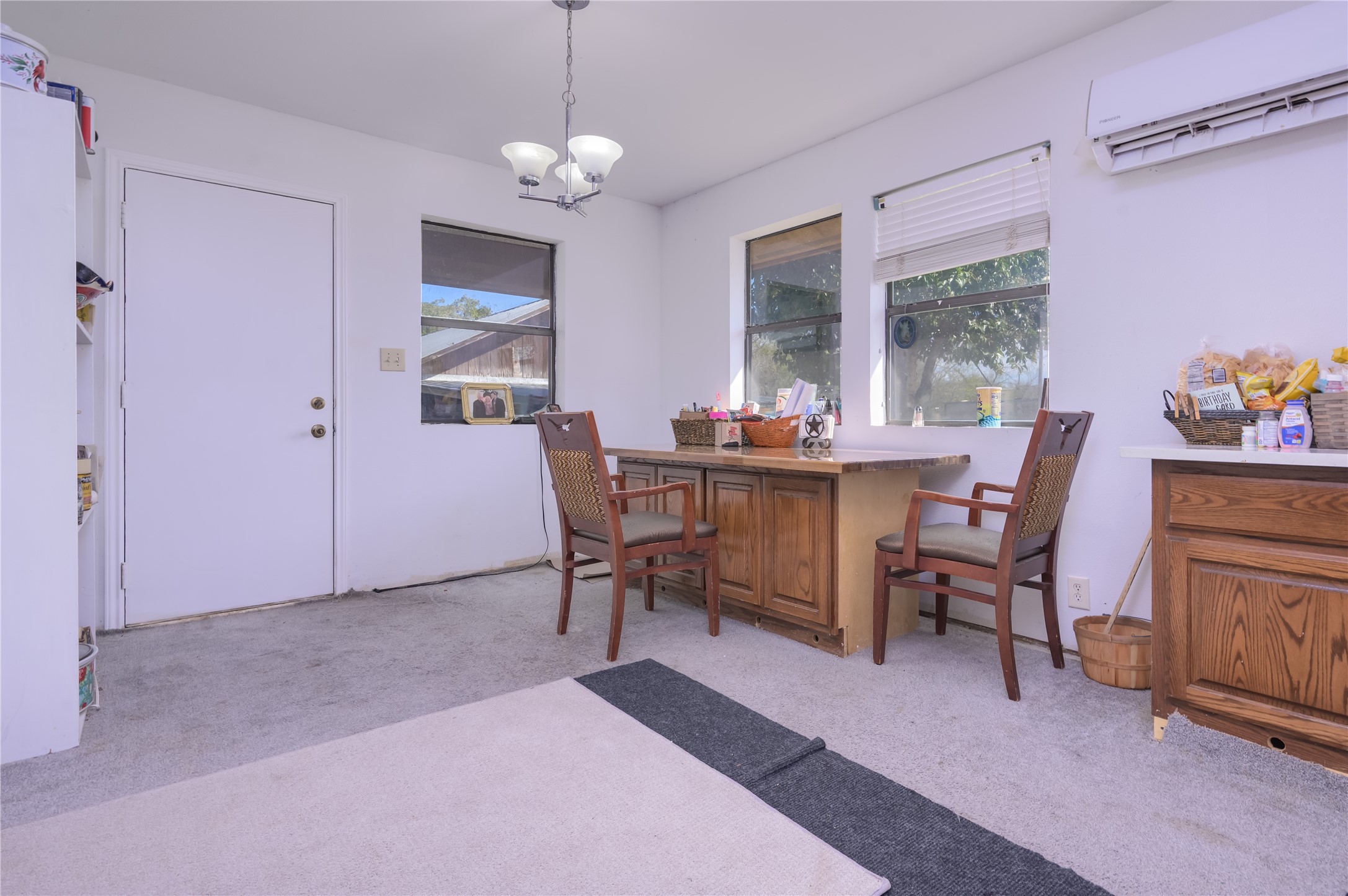 368 Lytton Lane Dale, TX 78616 - Photo 15 of 29 Dining space featuring an AC wall unit, a chandelier, and light carpet