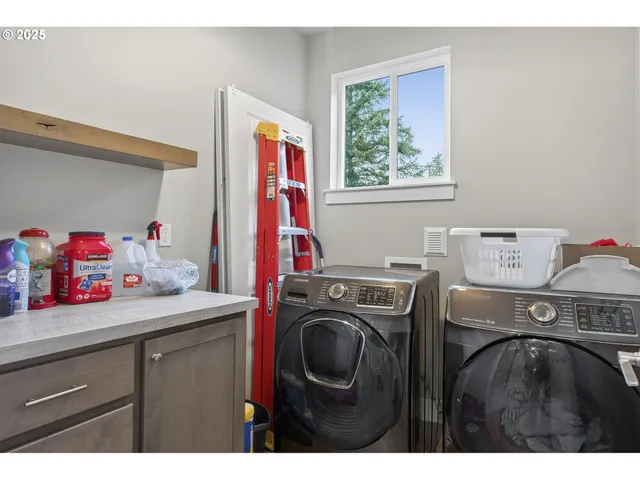 a utility room with sink dryer and washer