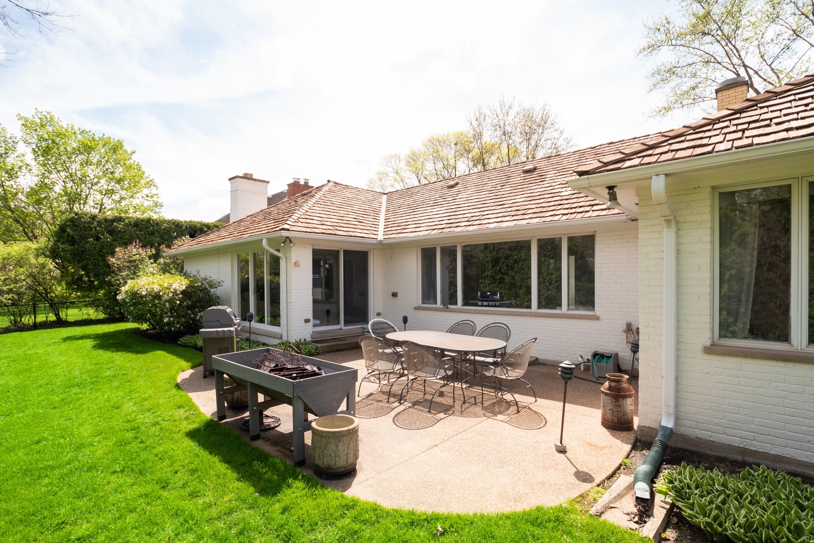 77 Brandon Road Northfield, IL 60093 - Photo 16 of 18 a view of a house with backyard sitting area and garden