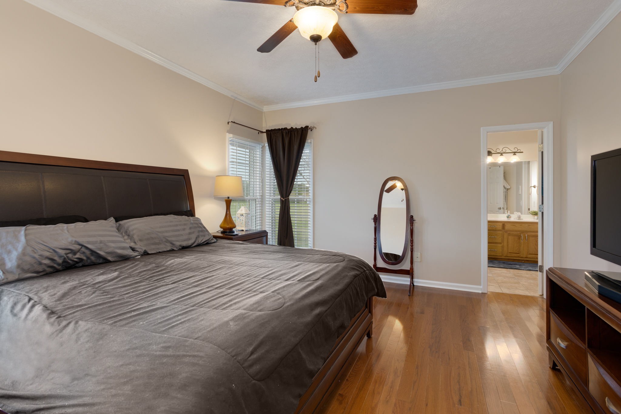 621 Jackson Road Portland, TN 37148 - Photo 21 of 32 a bedroom with a bed large mirror and tv