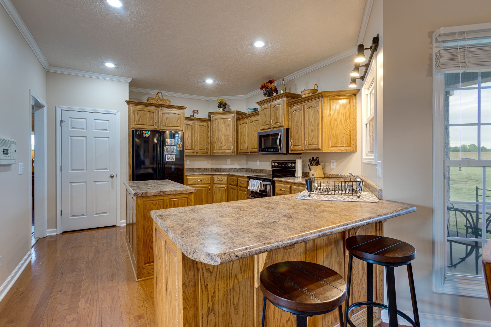 621 Jackson Road Portland, TN 37148 - Photo 10 of 32 a kitchen with a table chairs refrigerator and cabinets