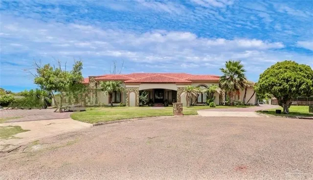 a front view of house with yard and trees