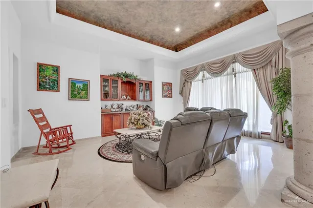 a bedroom with furniture and a flat screen tv