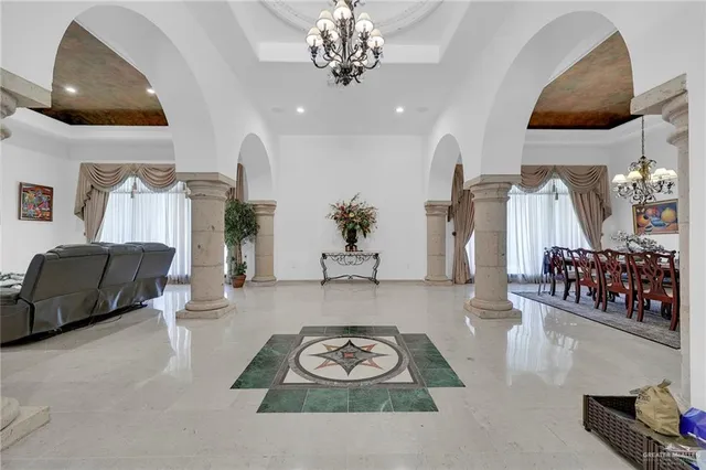 a view of kitchen with stainless steel appliances granite countertop a refrigerator and a stove top oven