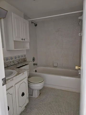 a bathroom with a sink a toilet and bathtub