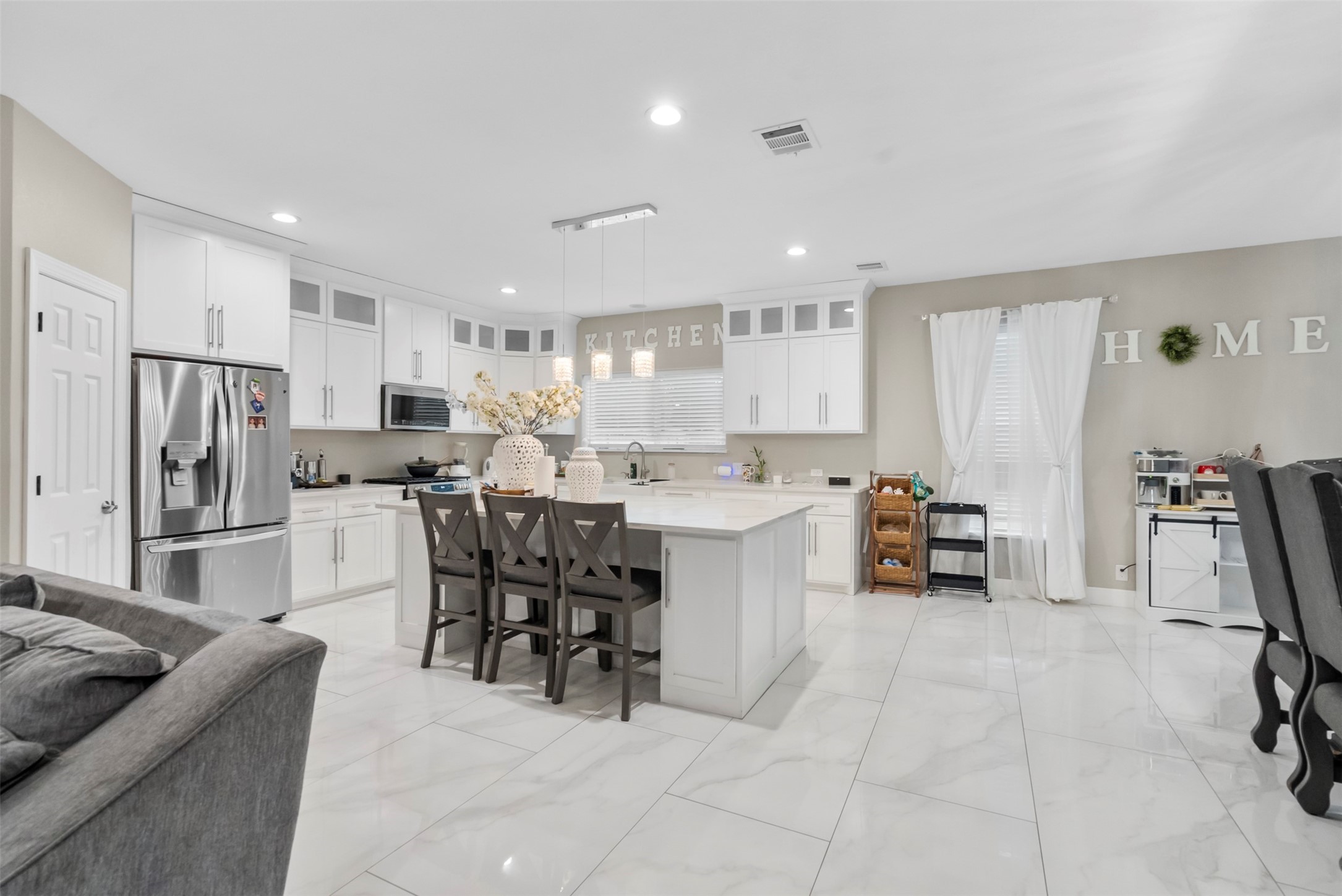 21502 Flint Trail Porter, TX 77365 - Photo 11 of 38 a kitchen with stainless steel appliances a sink a stove a refrigerator cabinets and chairs