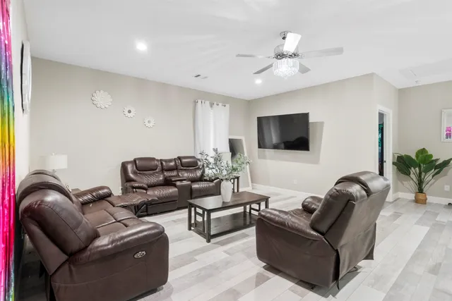 a bedroom with a bed dresser and a chandelier