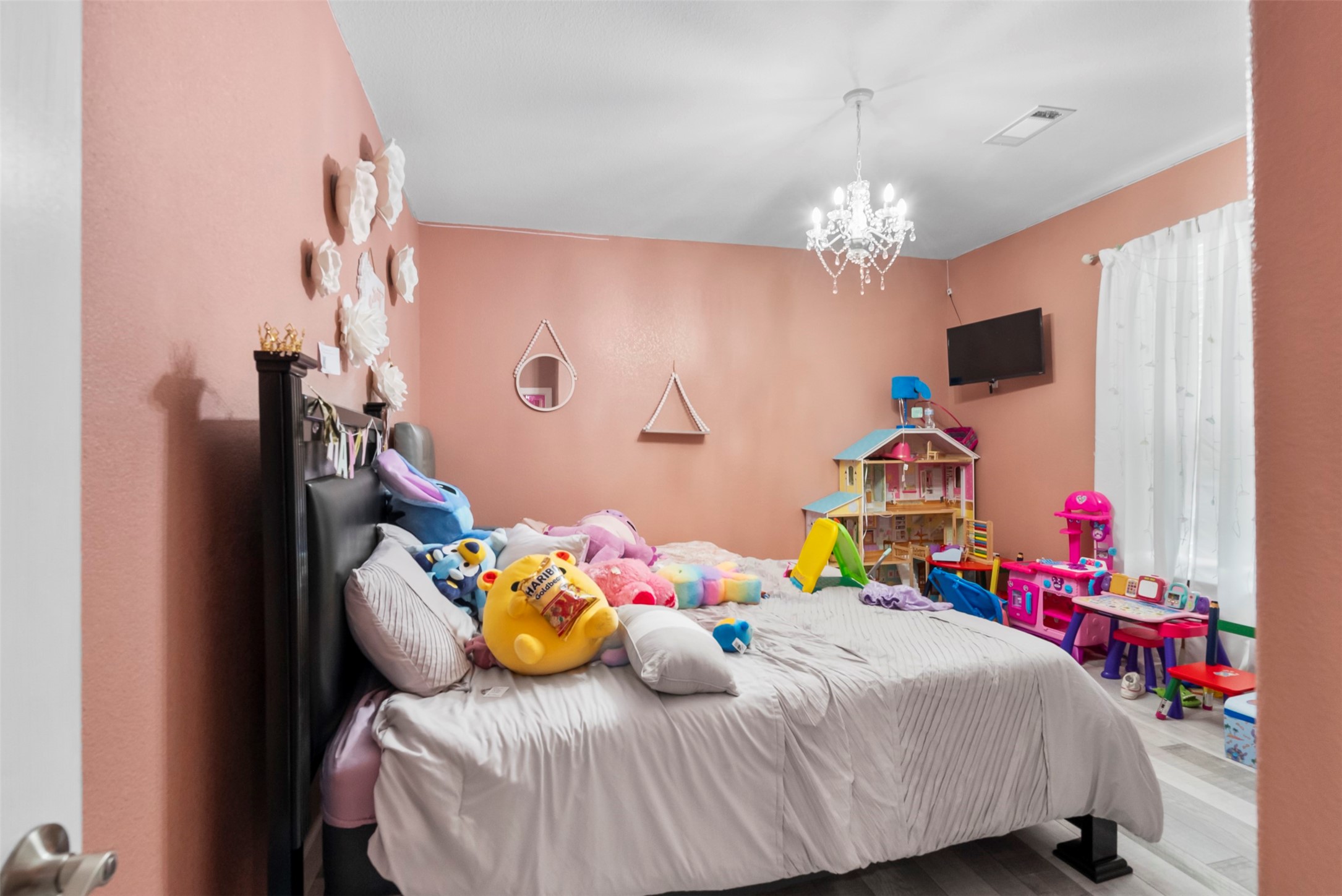 21502 Flint Trail Porter, TX 77365 - Photo 19 of 38 a bedroom with a bed dresser and a chandelier
